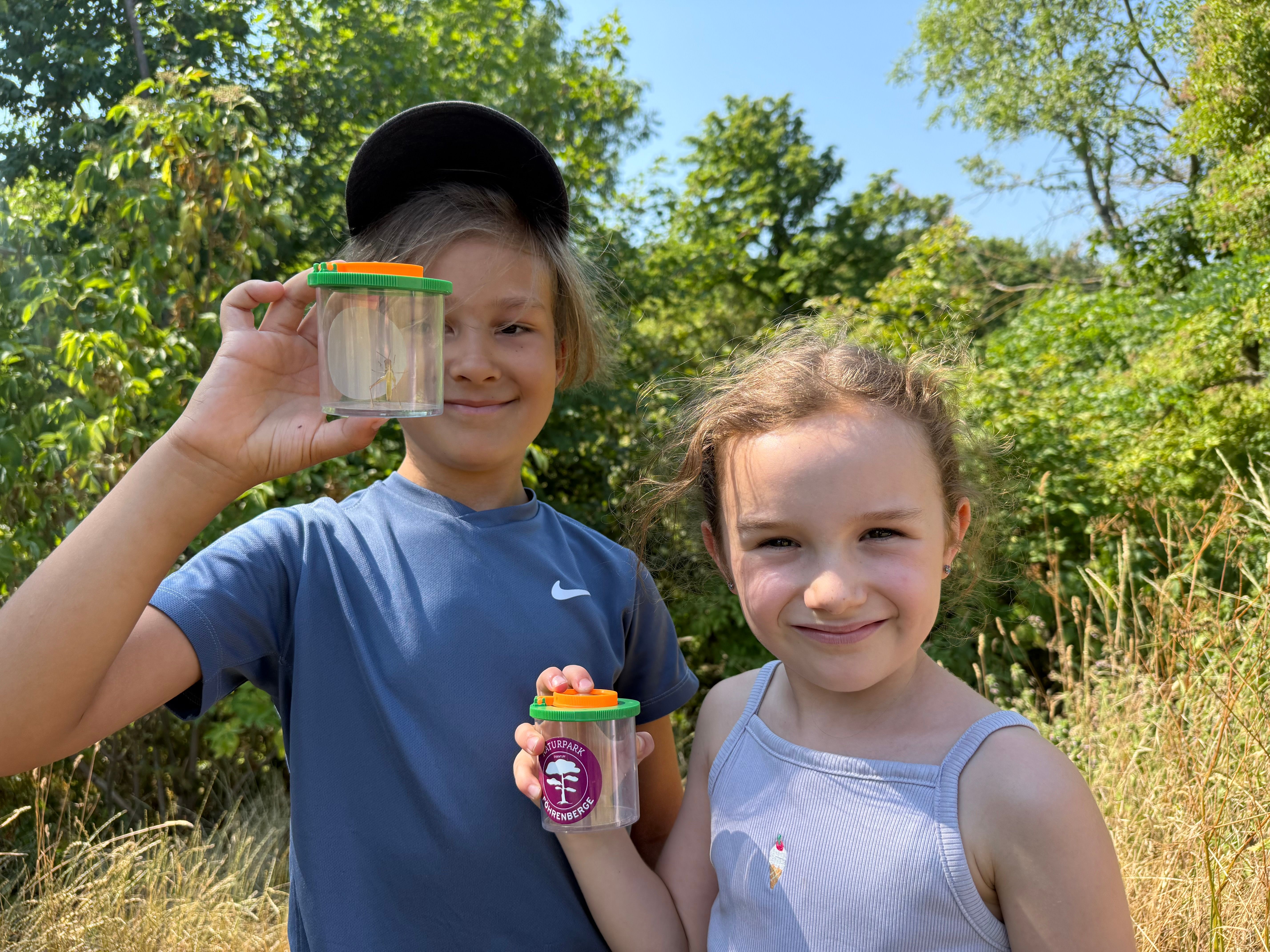 Kinder mit Becherlupe